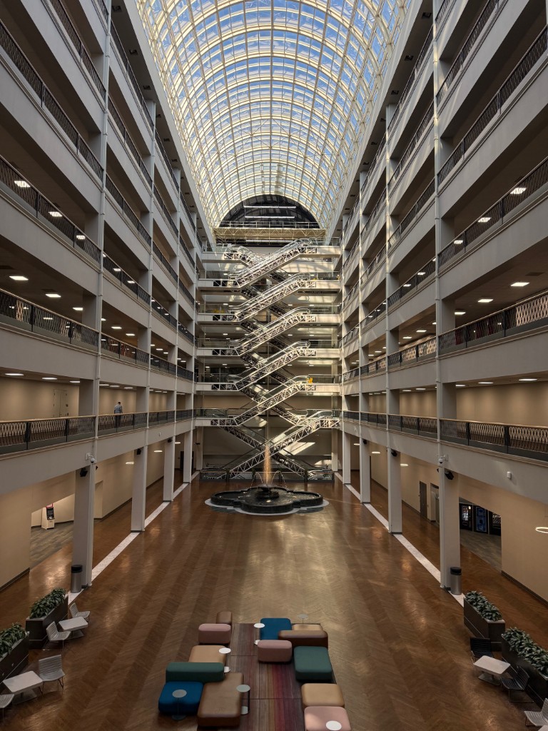 The iconic Infomart building atrium in Dallas with its distinctive glass ceiling and central escalators